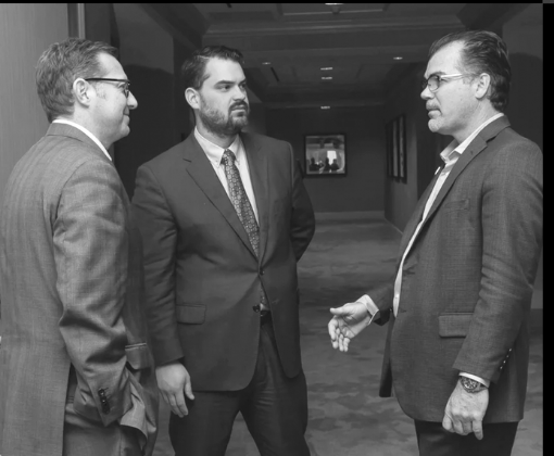 Three principals in candid conversation at an EFOGI event